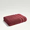 light red towel folded up on light grey background