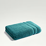 teal towel folded up on light grey background