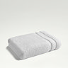 white towel folded up on light grey background