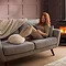 image of woman reclining on sofa with feet in boucle heated foot warmer