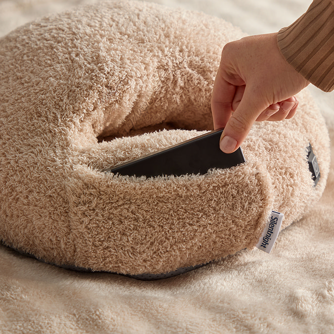 close up on back of heated foot warmer, with small pouch to put phone