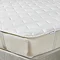 close up on corner of a bed with elastic strap securing a mattress topper in place