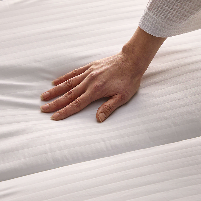 close up on hand brushing across the duvet texture