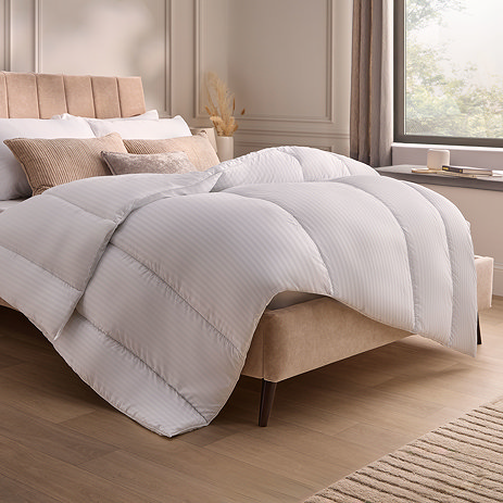 thick uncovered duvet atop a bed
