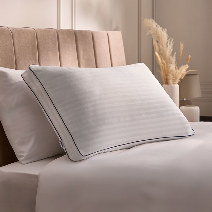 white box pillow on a bed