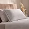 white box pillow on a bed