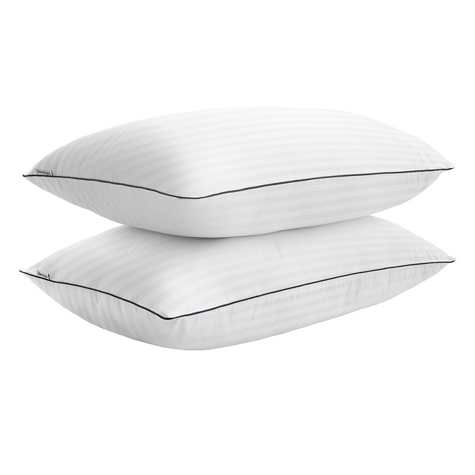 two hotel style pillows stacked on top of each other, cut out on white background