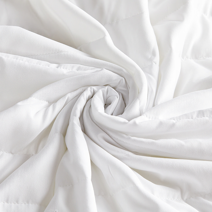Silentnight quilted mattress protector on bed close up image  3