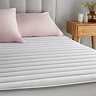 Silentnight quilted mattress protector on bed image 1