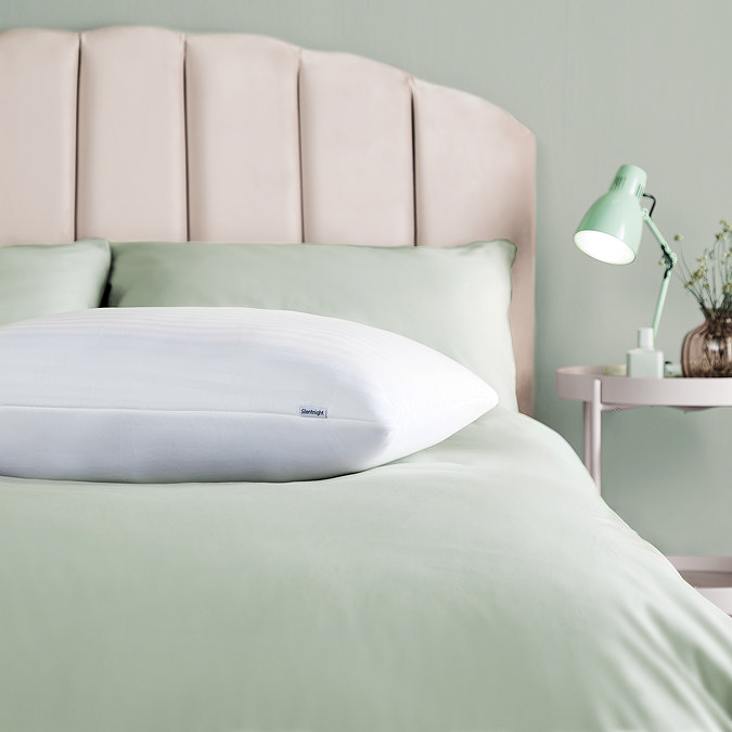 Sink in pillow on bed image 2