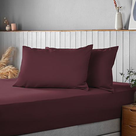 Supersoft Pillowcases in berry on bed image 1
