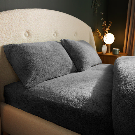 Teddy Fleece Fitted Sheet in Charcoal on bed image 1