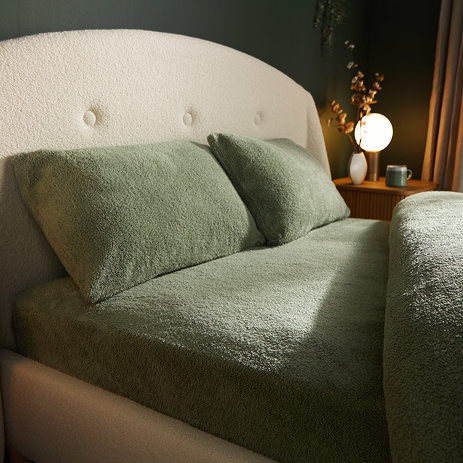 Teddy Fleece Fitted Sheet  in sage on bed image 1