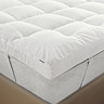 close up on corner of bed with 10cm deep mattress topper, fastened to the bed with elastic strap
