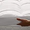 image of person lifting between a mattress topper and the bed