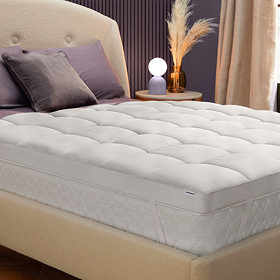 image of bed with white 10cm deep mattress topper on top