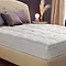 image of bed with white 10cm deep mattress topper on top