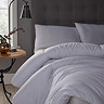 second close up of thick uncovered duvet on grey velvet bed