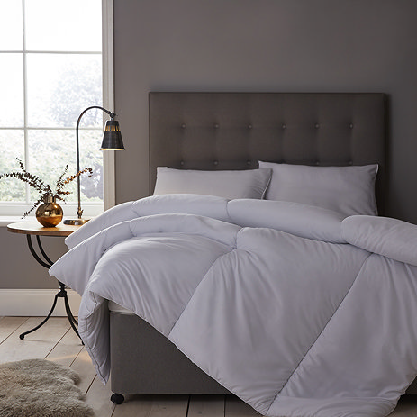 uncovered duvet on grey velvet bed