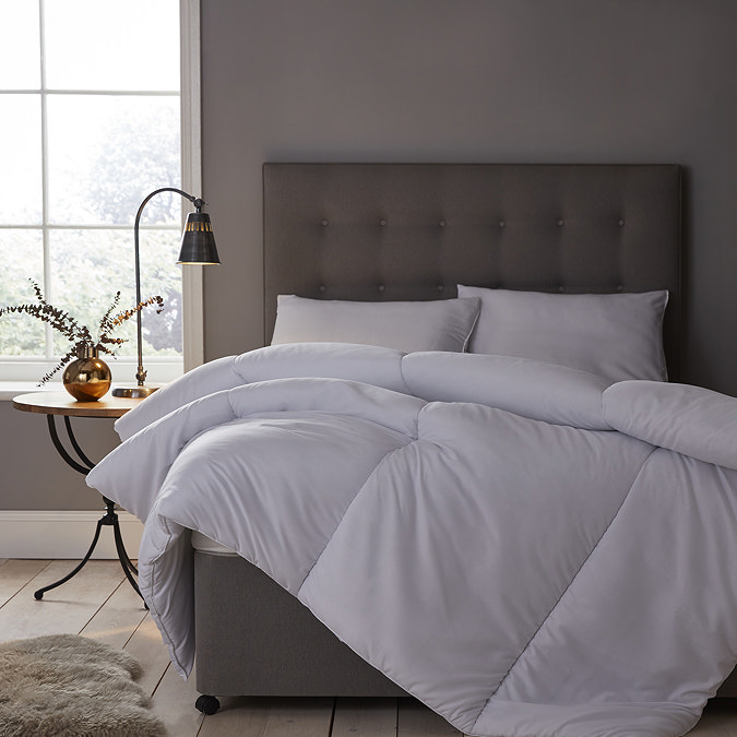 uncovered duvet on grey velvet bed