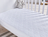 Cot bed mattress protector on bed image 1