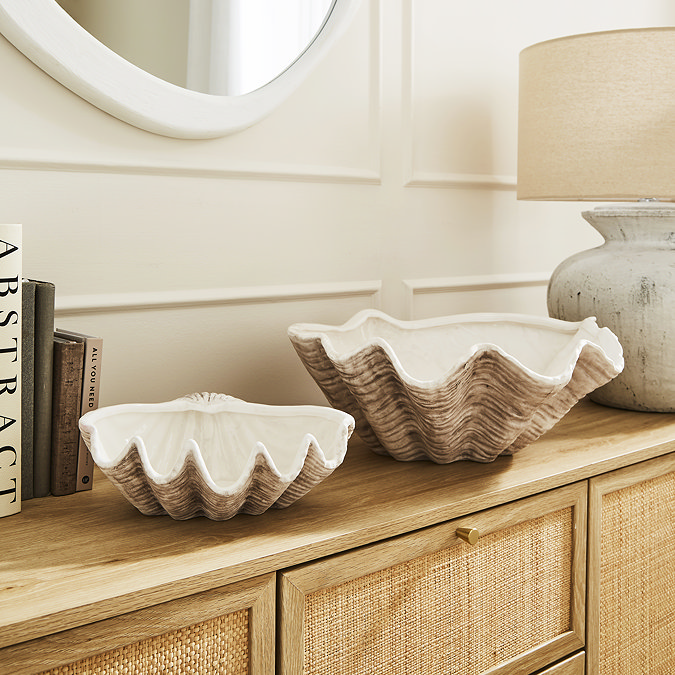 a large and medium shell shaped bowl on shelf