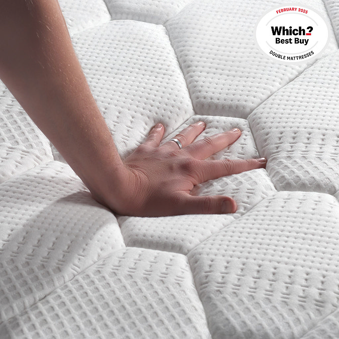 close up on the texture of mattress fabric, with hand touching it