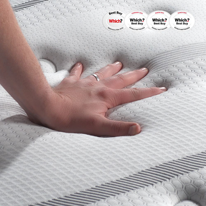 image of top of mattress with hand pressed down on it to feel texture and firmness