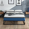 front-on image of double mattress with blue base, pushed against light blue wall