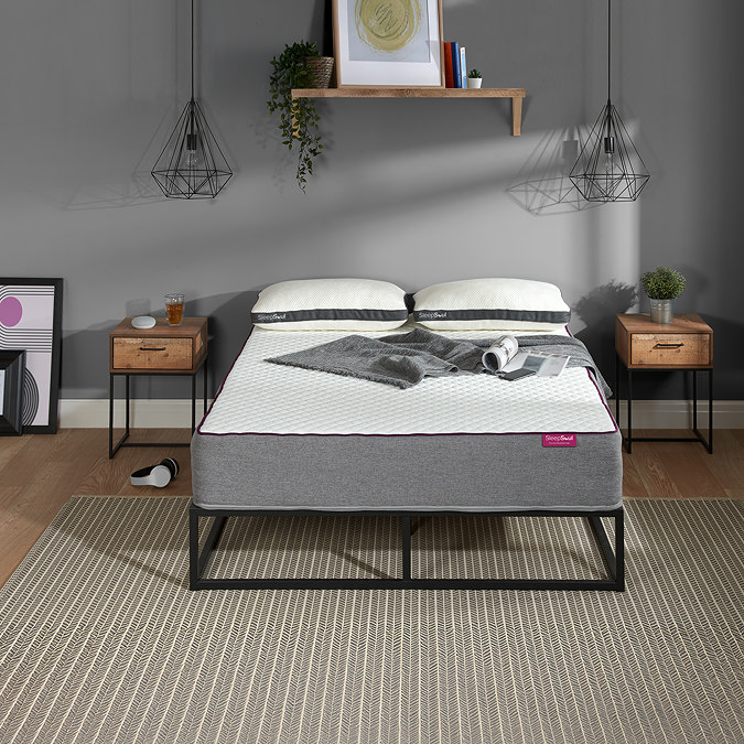 front on image of double mattress on a black bedframe, against a grey wall