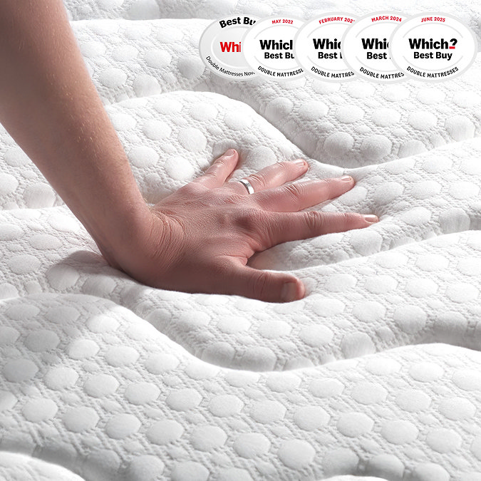 close up on hand touching top of mattress to feel texture and firmness
