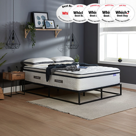 side-on image of deep double mattress on black metal frame against slate-grey wall