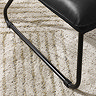 close up image of sleek black metal legs of industrial lounge chair