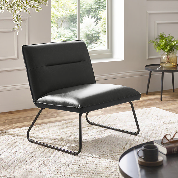 image of squared black faux leather lounge chair on beige carpet of modern living room
