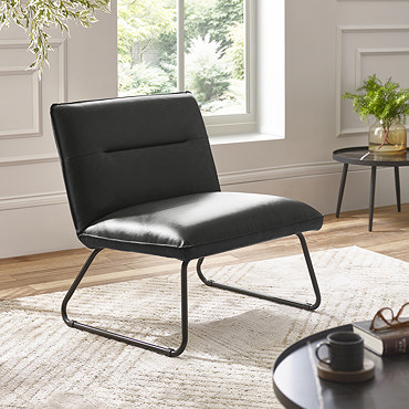 close up image of faux leather lounge chair with sleek black legs