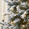close up on snowy branches of artificial christmas tree with warm white LEDs