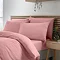 side-on image of coral pink duvet cover set, folded over slightly to show matching fitted sheet and pillowcases