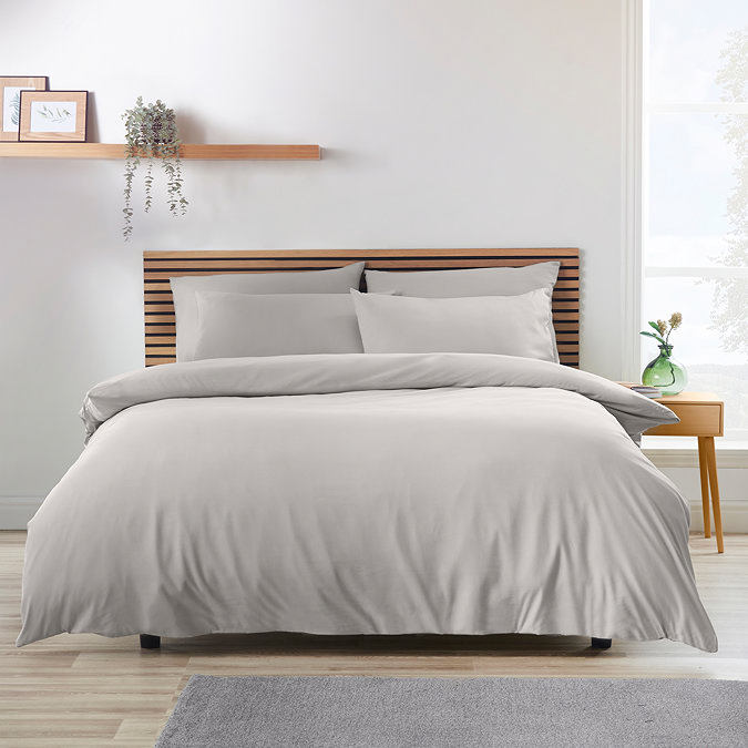 light grey duvet cover set on a bed with nordic headboard