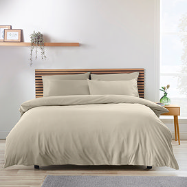 natural light brown coloured duvet cover set on a bed with Nordic headrest