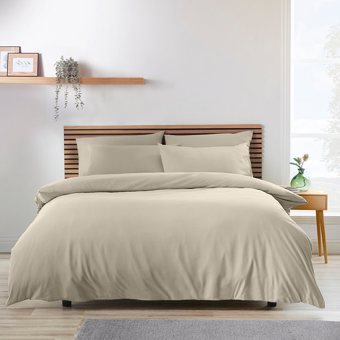 natural light brown coloured duvet cover set on a bed with Nordic headrest