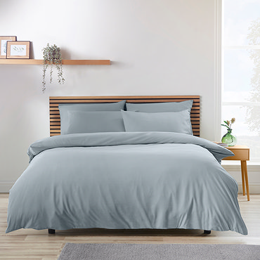 side-on image of slate grey duvet cover set, folded over at the top to reveal matching fitted sheet and pillowcases