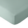 image cut out on white background of light green fitted sheet over corner of a mattress