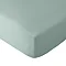image cut out on white background of light green fitted sheet over corner of a mattress