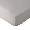 close up on corner of mattress with grey fitted sheet