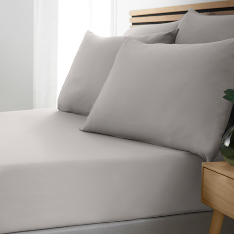 side-on image of bed with grey fitted sheet and matching pillowcases