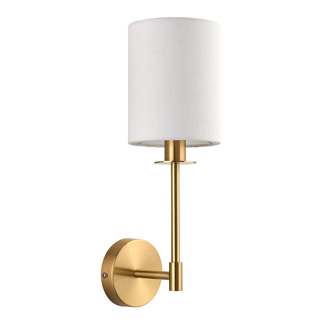 image cut out on white background of wall light with cylindrical white linen shade and satin brass arm
