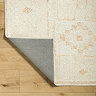 image of ivory rug with beige scandi pattern, corner folded up slightly to reveal material underneath