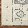 close up image of ivory rug with black scandi pattern, focus on colour and pattern