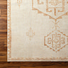 close up image of corner of ivory rug with burnt orange scandi pattern, focus on colour and texture