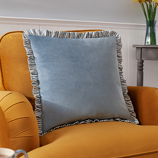 Solene ruffle feather cushion on chair image 1